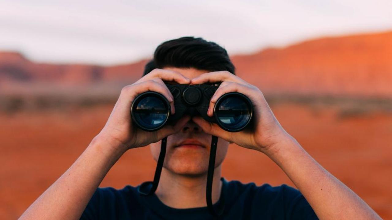 Person looking through binoculars