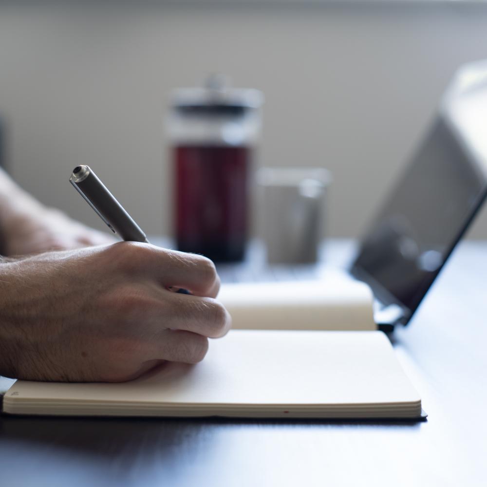 hand writing with laptop