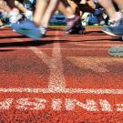People's feet crossing a finish line.
