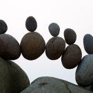 Rows of rocks balanced between two boulders.