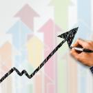 Person's hand drawing a graph.